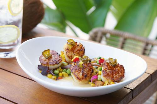 a plate of food with shrimp and vegetables on a table at Hilton Garden Inn St. Pete Beach, FL in St Pete Beach