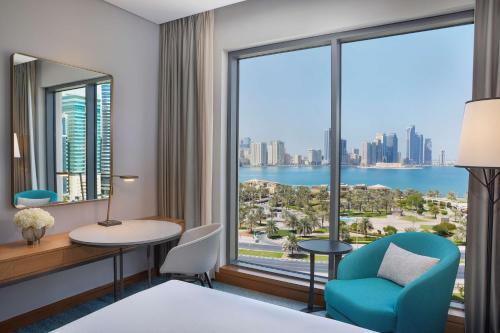 a hotel room with a view of the city at DoubleTree by Hilton Sharjah Waterfront Hotel And Residences in Sharjah