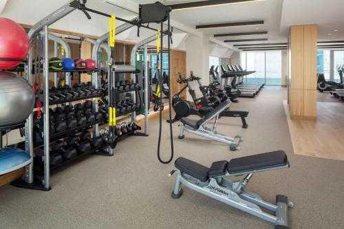a gym with lots of exercise equipment in a building at Conrad Nashville in Nashville