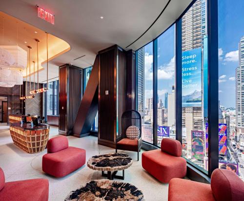 a hotel lobby with a view of the city at Tempo By Hilton New York Times Square in New York