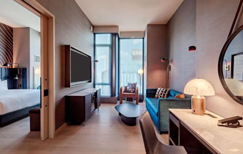 a hotel room with a bed and a television at Tempo By Hilton New York Times Square in New York