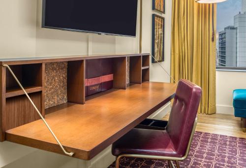 a room with a desk with a tv and a chair at Canopy By Hilton Chicago Central Loop in Chicago