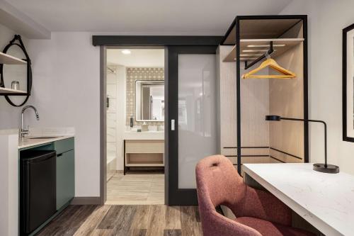 a kitchen with a desk and a chair in a room at DoubleTree by Hilton New York Midtown Fifth Ave in New York