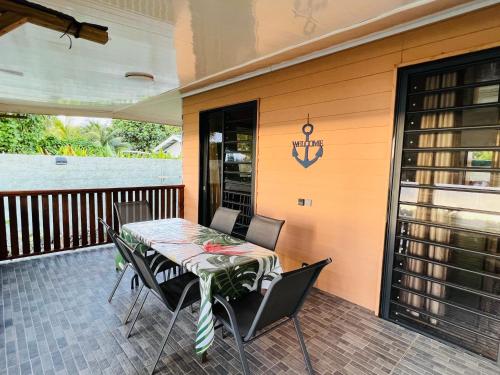 a patio with a table and chairs on a deck at Villa Toa Pearl Bora Bora in Bora Bora