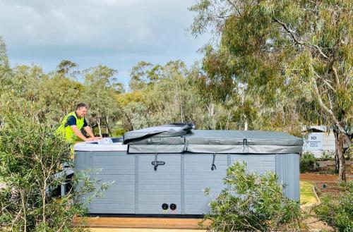 a man is standing next to a small trailer at Sandalwood Downs Fabulous Farm Stay TOODYAY in Toodyay