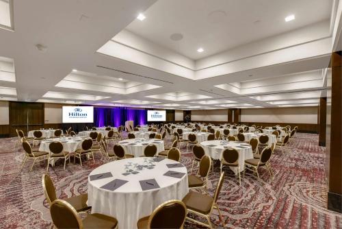 a banquet hall with tables and chairs and a stage at Hilton Los Angeles Airport in Los Angeles