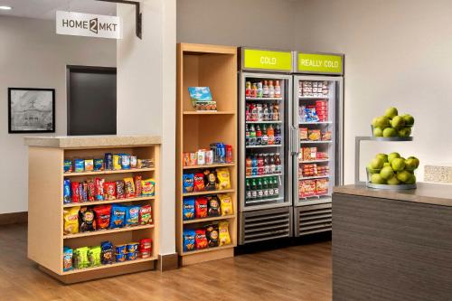 a grocery store aisle with two refrigerators and food at Home2 Suites by Hilton Lexington University / Medical Center in Lexington