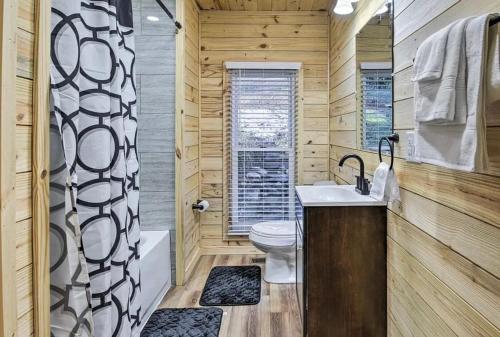 a bathroom with a toilet and a sink and a shower at Smokey Mountain Hideaway in Gatlinburg