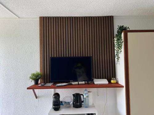 einen Computermonitor auf einem Regal in einem Raum in der Unterkunft Studio de l'Anse Mitan in Les Trois-Îlets