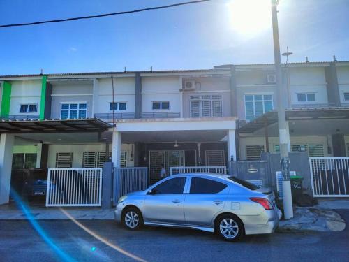 a car parked in a parking lot in front of a house at Humaira Homestay Jitra in Jitra