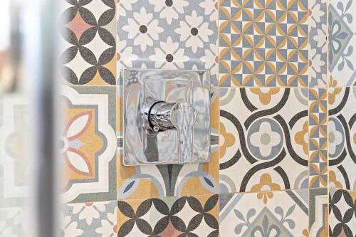 a bathroom with a glass object on a tile wall at Adorable house with Amazing water front of canal in Pompano Beach