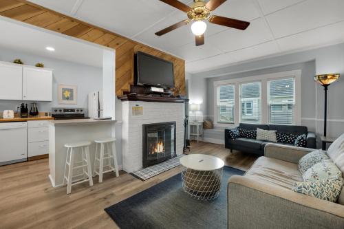a living room with a couch and a fireplace at The Tides by the Sea in Seaside