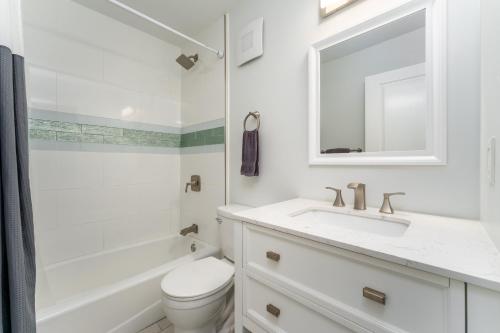 a white bathroom with a sink and a toilet at Beautiful Ocean View Maui A Safe Place To Stay in Kahana