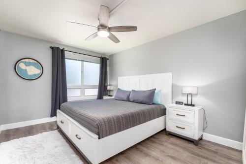 a bedroom with a bed and a ceiling fan at Beautiful Ocean View Maui A Safe Place To Stay in Kahana