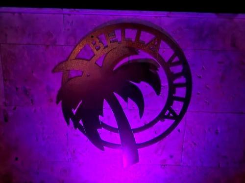 a purple wall with a palm tree painted on it at Bella Villa Roomy apartment at 5 min walk to the beach in Las Galeras
