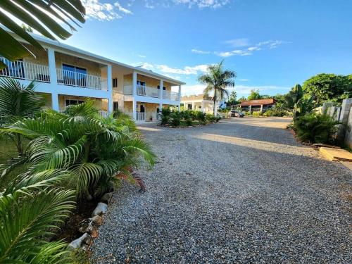 a road leading to a large apartment building at Roomy apartment at 5 min walk to the beach in Las Galeras