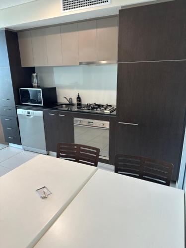 a kitchen with a table and chairs in a room at Embassy apartment free parking in Adelaide
