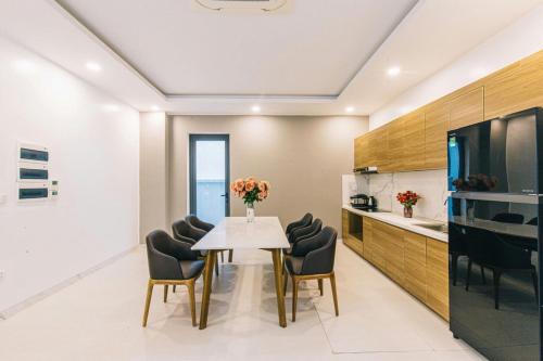 a dining room with a table and chairs at Sea Villa - FLC Sam Son in Sầm Sơn