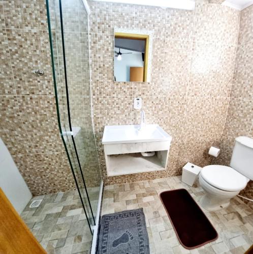 a bathroom with a toilet and a sink and a shower at ROUTE 333 in Miguel Pereira