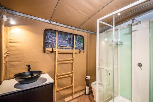 a bathroom with a sink and a shower at Magnetic Glamping Tent 4 in Nelly Bay