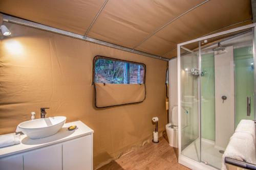 a bathroom with a sink and a shower at Magnetic Glamping Tent 5 in Nelly Bay