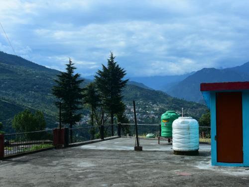 a balcony with a view of a mountain at maa kalishila home stay in Ukhimath