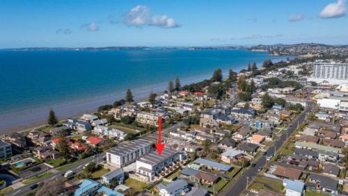 an aerial view of a city and the beach at Sunny Beachside Home in Orewa