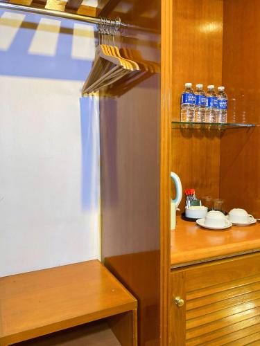 a kitchen with a counter with bottles of water at Hotel Sandakan in Sandakan