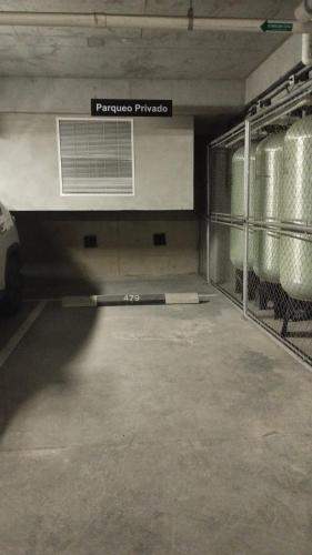 an empty parking garage with a car parked in it at Lovely and Peaceful Home in Guatemala
