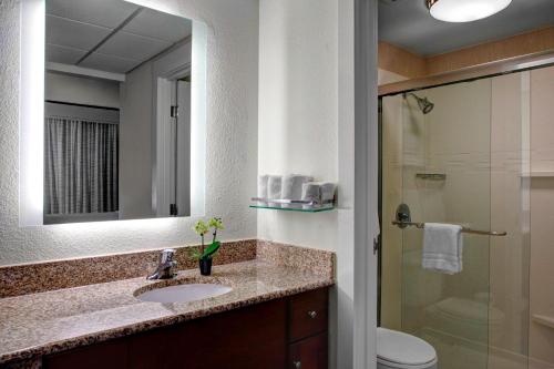 a bathroom with a sink and a toilet and a mirror at Residence Inn by Marriott Cleveland Downtown in Cleveland