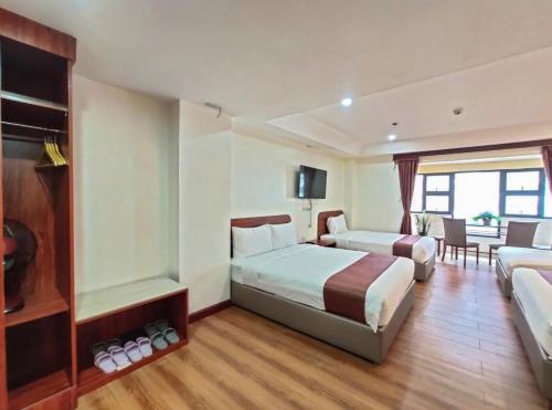 a hotel room with two beds and a television at 456 Hotel in Baguio