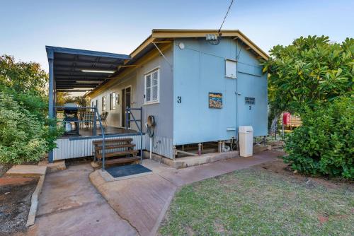 a small blue house with a porch and stairs at Getaway Villas Unit 3 in Exmouth