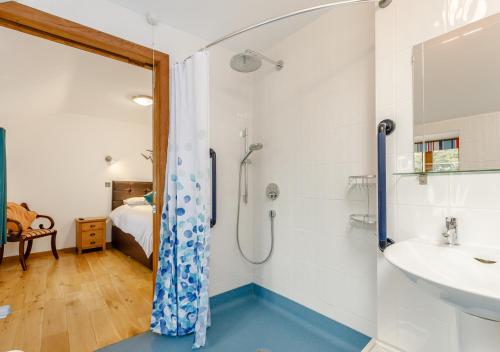 a bathroom with a shower and a sink at Otter Pool Barn in West Down