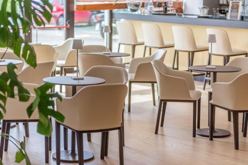 a row of tables and chairs in a restaurant at NEW IPOINT HOTEL in San Giovanni in Persiceto