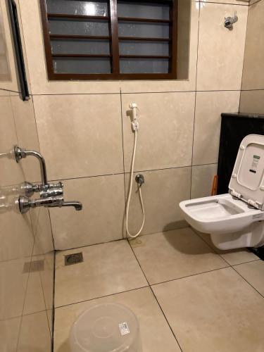 a bathroom with a toilet and a sink at Serene Villa in Puducherry