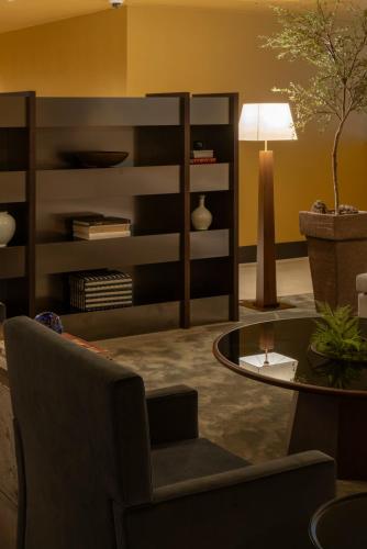 a living room with a chair and a table at Amid Hotel Seoul in Seoul