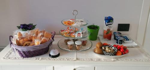 a table with three tiers of food on it at Residenza Guglielmi in Campobasso
