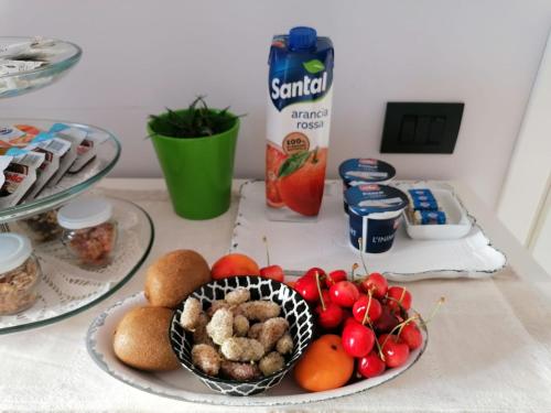 a table with two plates of food and a bowl of fruit at Residenza Guglielmi in Campobasso