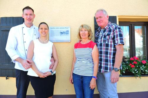 a group of three people standing in front of a building at Hotel-Gasthof Weisses Ross in Schwaig bei Nürnberg