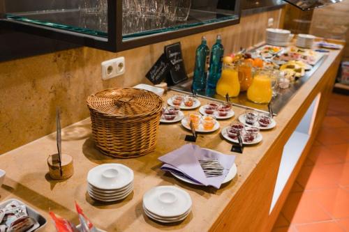 a buffet with plates of food on a table at Hotel-Gasthof Weisses Ross in Schwaig bei Nürnberg