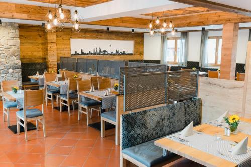 a restaurant with wooden walls and tables and chairs at Hotel-Gasthof Weisses Ross in Schwaig bei Nürnberg