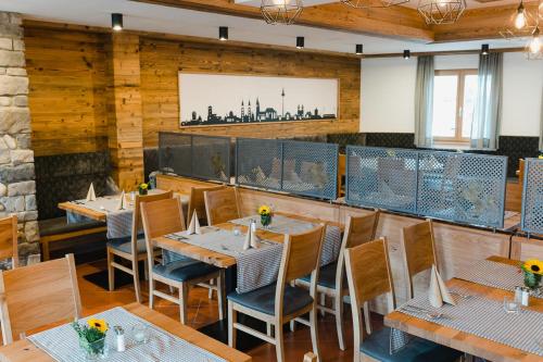 a restaurant with wooden walls and tables and chairs at Hotel-Gasthof Weisses Ross in Schwaig bei Nürnberg