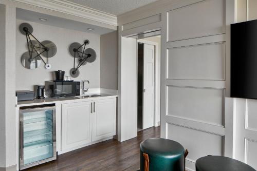 a kitchen with white cabinets and a microwave at Ann Arbor Marriott Ypsilanti at Eagle Crest in Ann Arbor