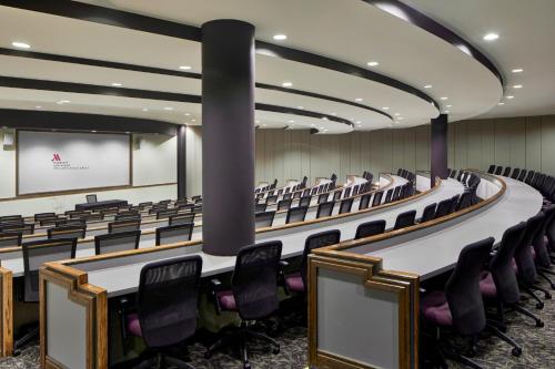 an empty lecture hall with desks and chairs at Ann Arbor Marriott Ypsilanti at Eagle Crest in Ann Arbor