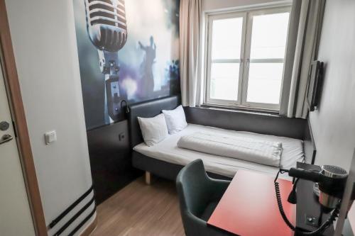 a small room with a bed and a window at Comfort Hotel Malmö in Malmö