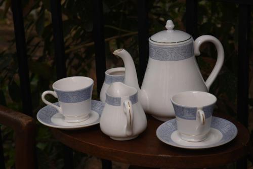 a group of cups and vases on a table at Everdew Kandy Rooms in Kandy