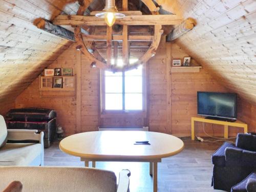 a room with a table and a tv in a cabin at 12 person holiday home in Selje-By Traum in Selje