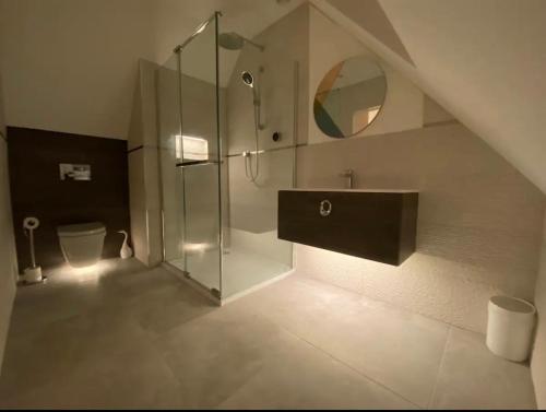 a bathroom with a glass shower and a toilet at The Cotswold Stowaway, Perfect Luxurious Retreat! in Stow on the Wold