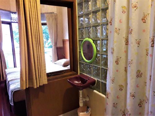 uma casa de banho com um espelho e um WC num quarto em Orange Home Syariah em Bandung