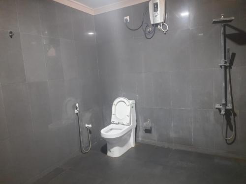 a bathroom with a white toilet in a stall at Hambantota Rest House in Hambantota